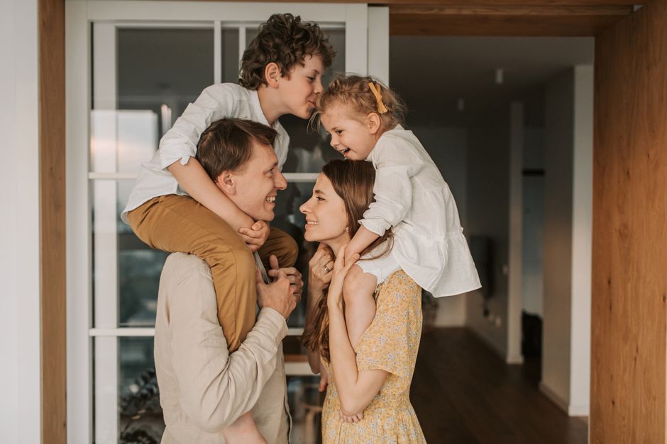 Parents sharing a playful moment with their children at home
