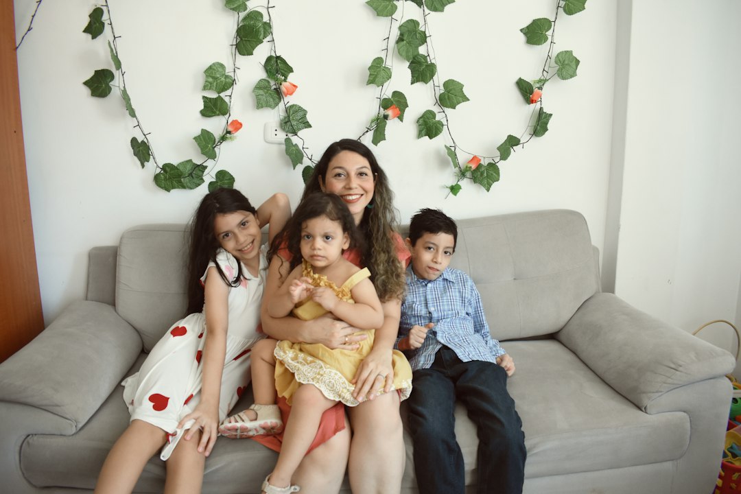 Parents and children sitting together on a sofa at home